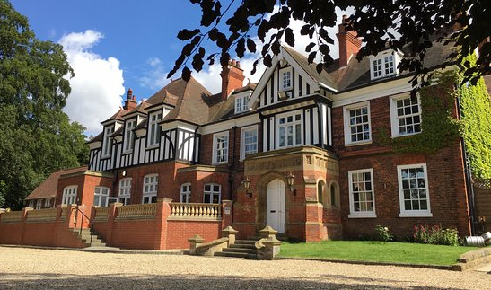 A black and white clad building in red brick